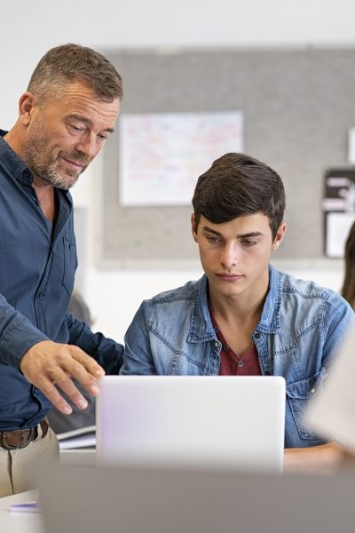 Young tutor helping a student with his homework, learning and education concept